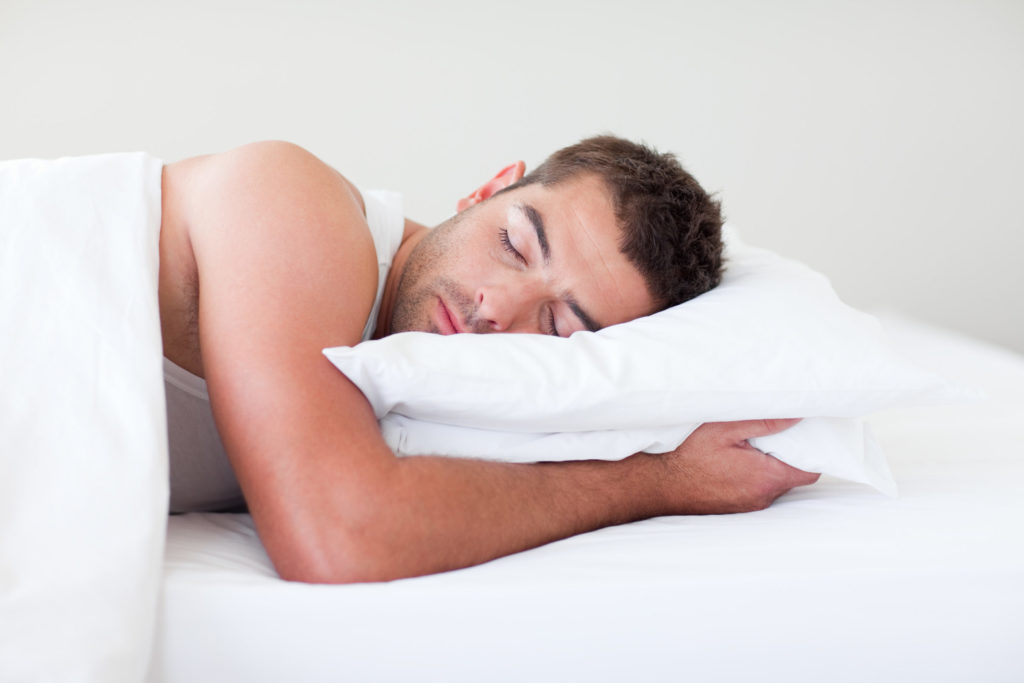 man sleeping with pillow