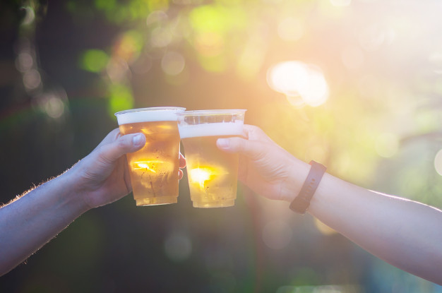 celebration-beer-cheers-concept-close-up-hands-holding-up-glasses-beer