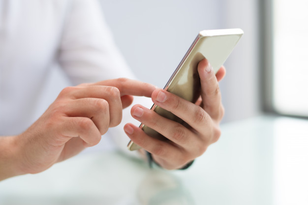 close-up-male-hands-using-smartphone