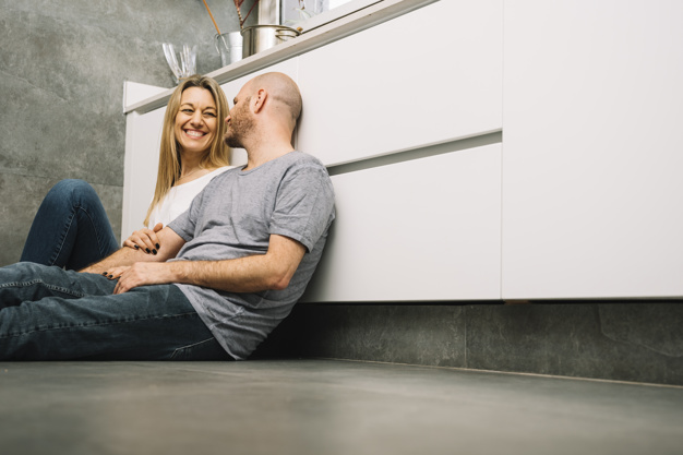 Couple in love on floor in kitchen 