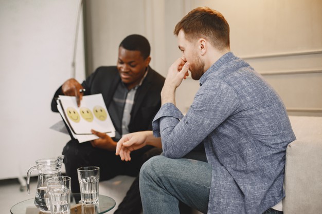 man at pshycoterapist. professionalist showing the patient pictures, doing test