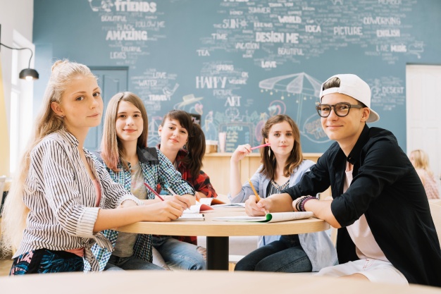 group-students-posing-table