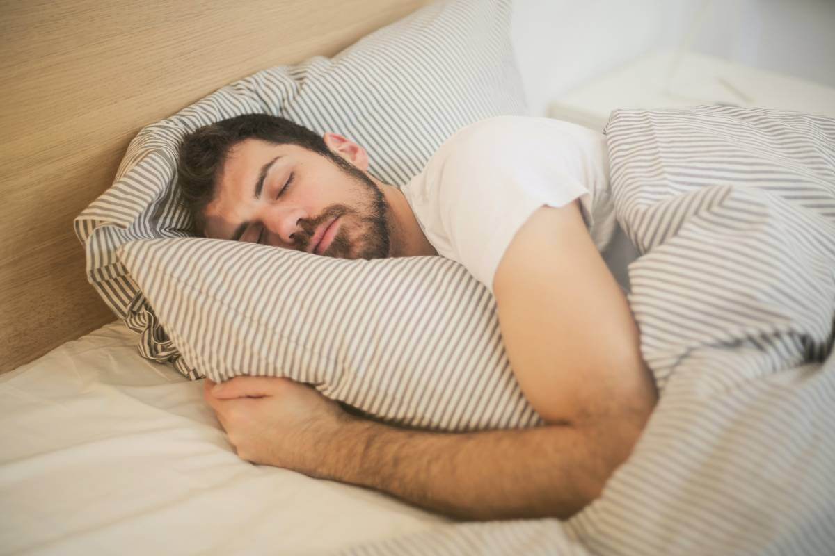 Man sleeping in bedroom at home 