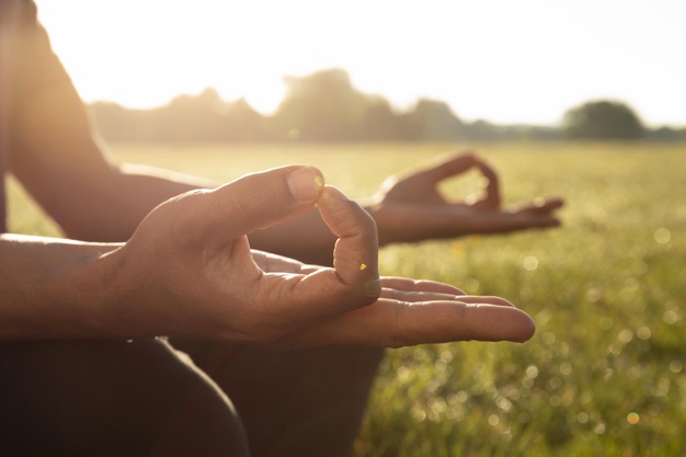 man meditating outdoors