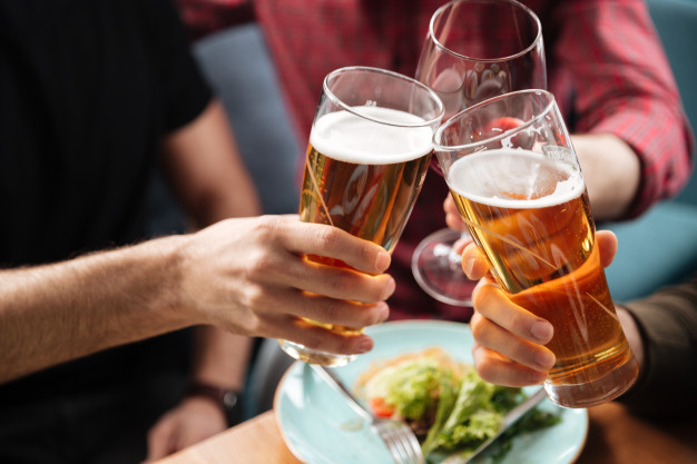 young-friends-sitting-cafe-while-drinking-alcohol