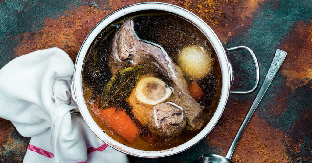 Broth soup in a cooking pot
