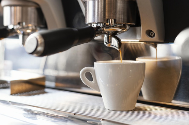 close-up-machine-pouring-coffee-cup