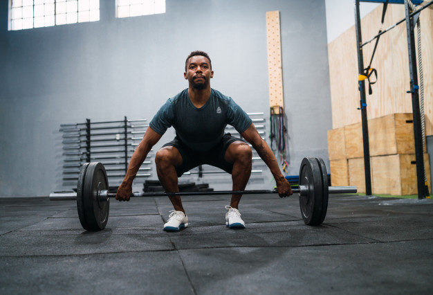 athlete doing exercise with a barbell