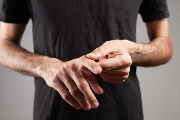 man-has-sore-finger-gray-background