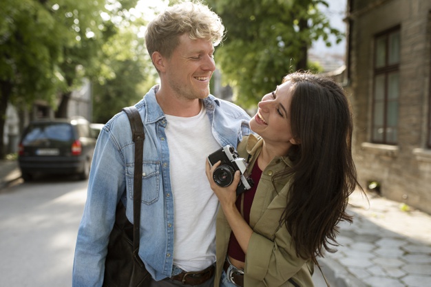 happy couple with photo camera 