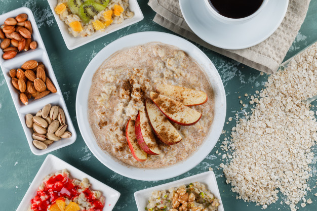 oatmeal-plates-with-fruits-jam-nuts-cinnamon-coffee-oat-flakes