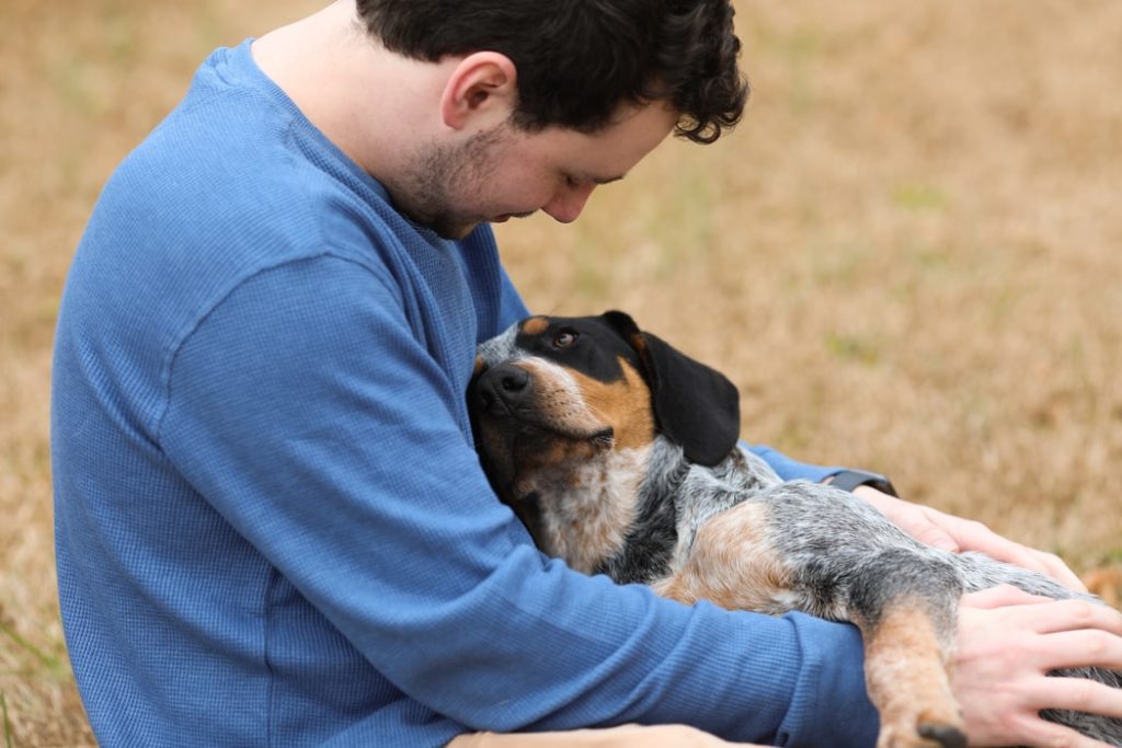 man hugging a dog