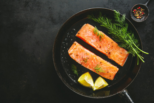 Raw salmon fish on vintage pan