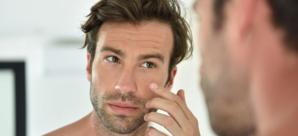 man checking his face