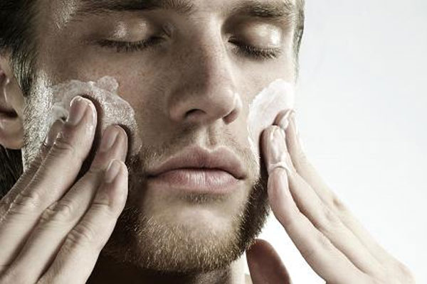 man cleansing his face; skincare steps for men