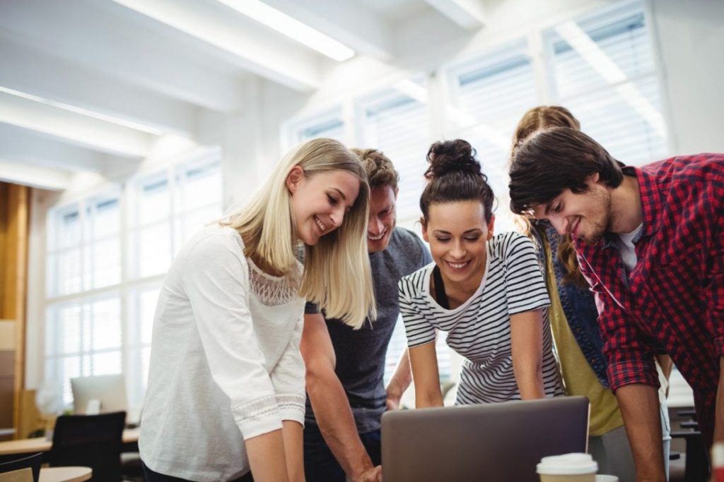 Group of business executives using laptop at their desk 