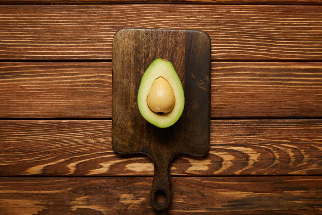 cut avocado on wooden background