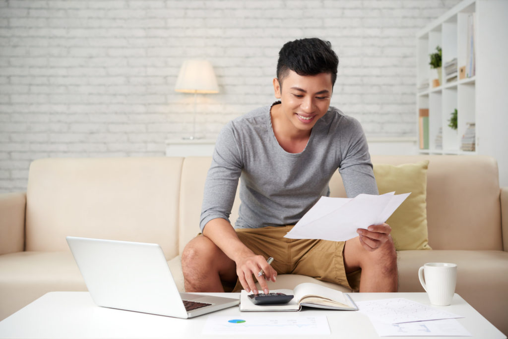 Young asian man working at home