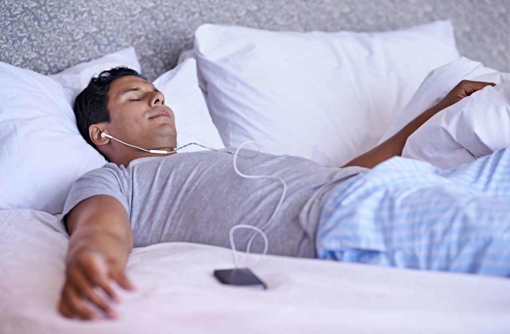 Man Sleeping Listening Music on bed