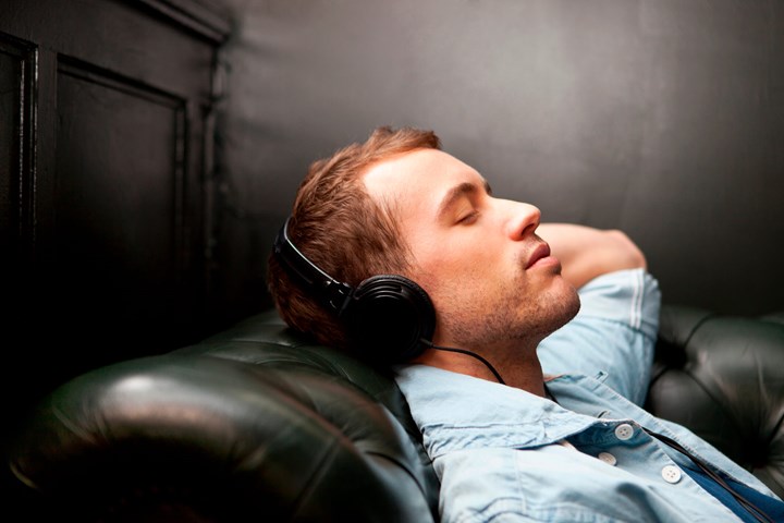 Man Sleeping Listening Music At Home