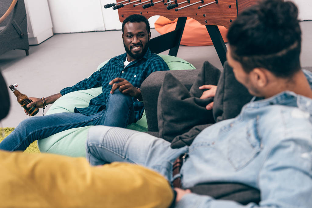 group of multiethnic friends sitting and talking to each other