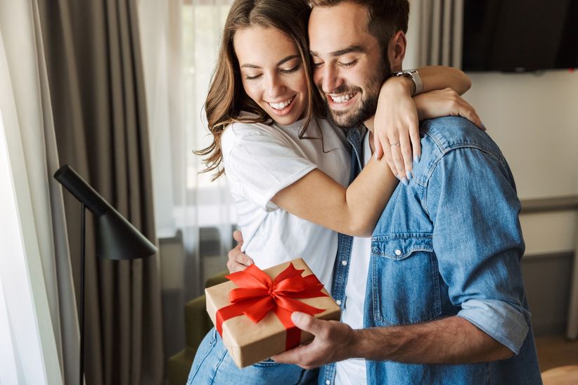 man giving gift to girlfriends