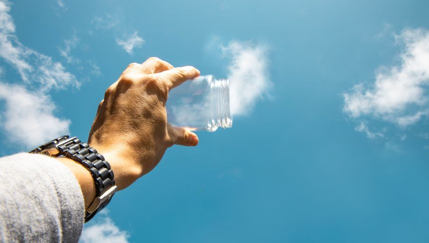  man holding a bottle catching cloud