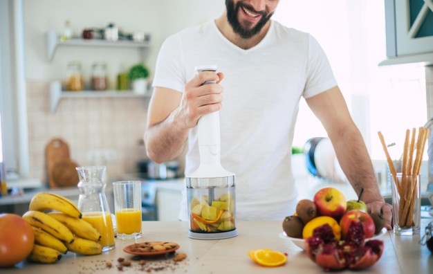  Man mixing fruits with blender