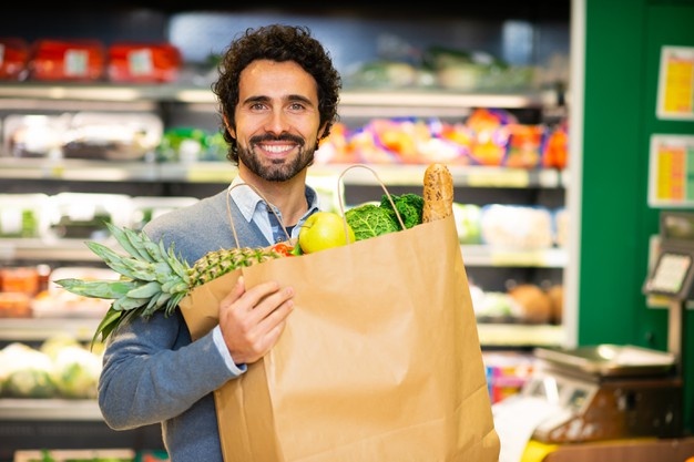 Man holding an healthy food bag in a grocery store