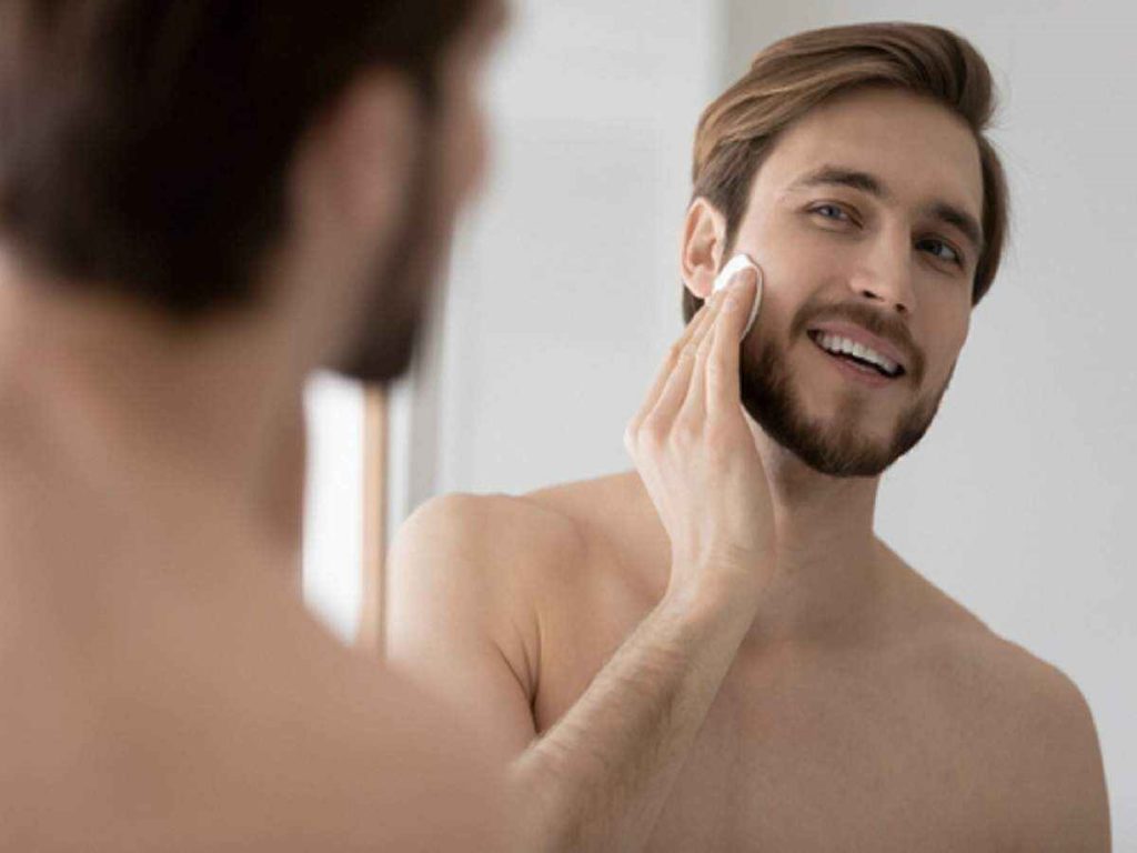 Man Cleaning Face with Toner 