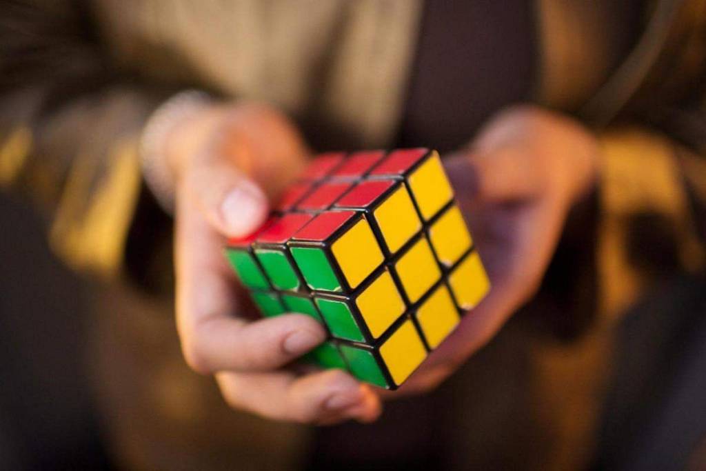 man holding Rubiks cube 