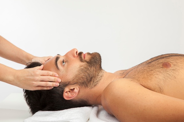 man Relaxing face and hair massage 