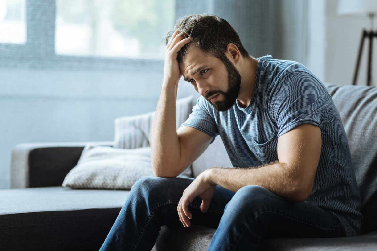 Sad Man Holding His Forehead 
