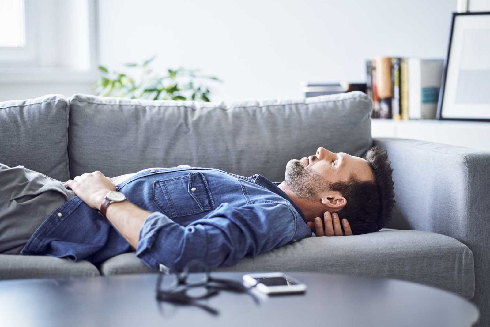 man relaxing on sofa 