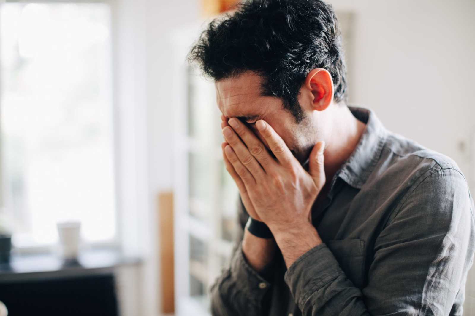 Sad Gloomy Man Holding His Forehead 