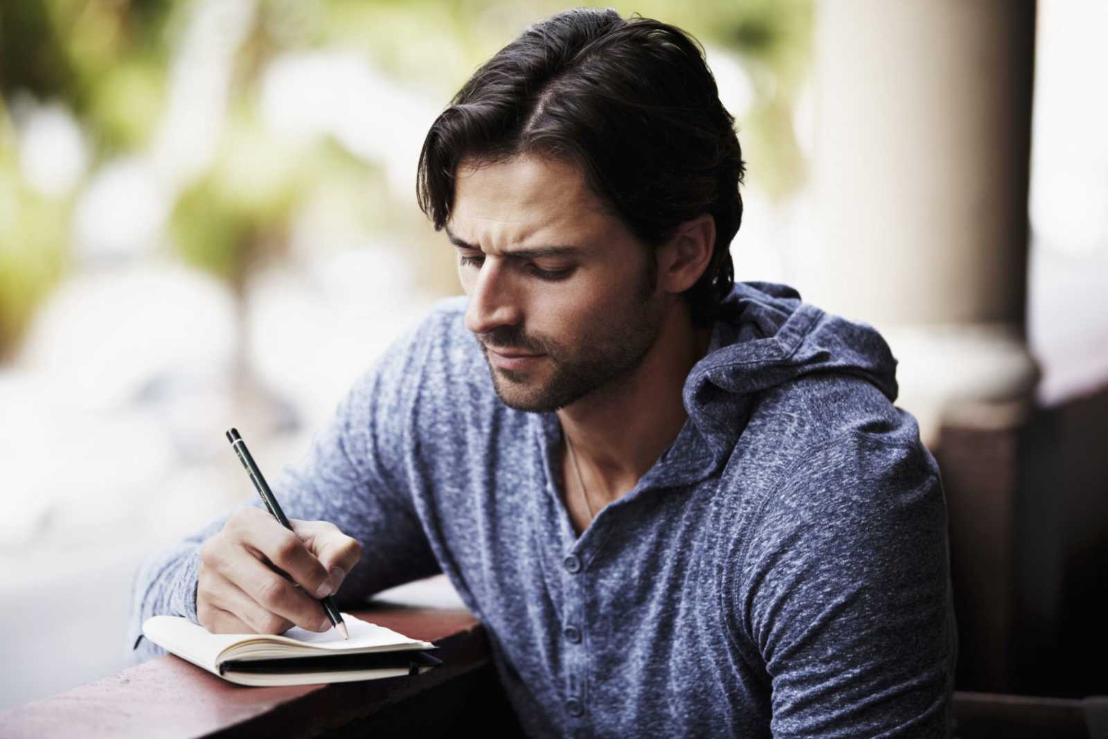  Man writing on book