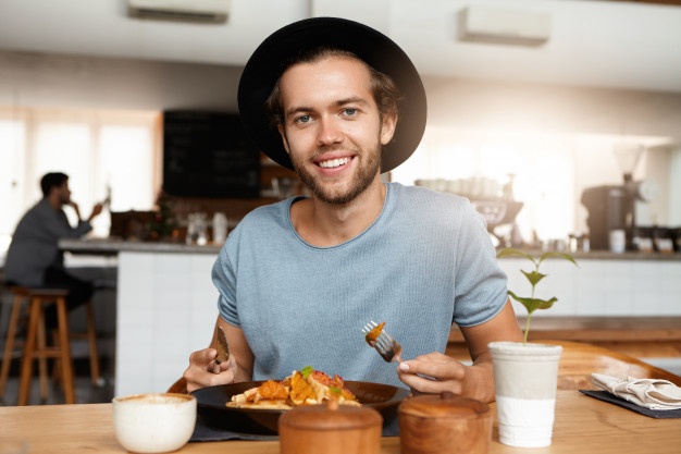 male with beard appeasing hunger while dining alone at modern restaurant on sunny day, eating meal with knife and fork Sleepless Man in his Bed 
