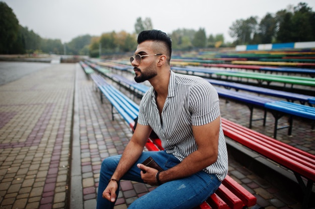 Handsome tall arabian beard man model at stripped shirt posed outdoor