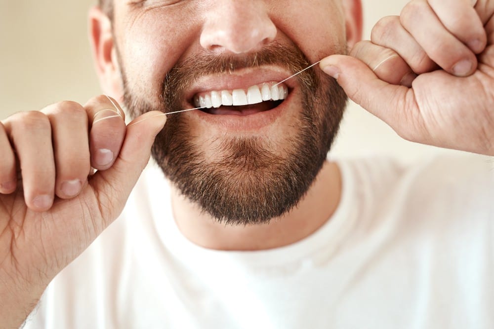 Man Flossing His Teeth Cleaning Teeth With Dental Floss