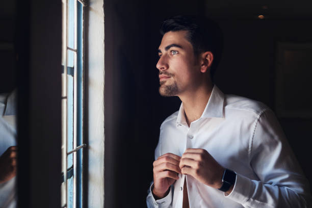  handsome young man getting dressed on his wedding day