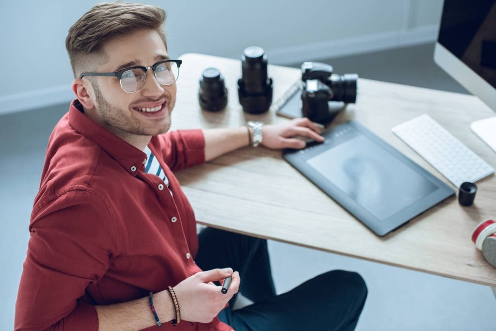 Happy Freelancer Man Sitting By Working Table