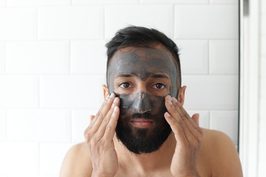 applying charcoal face mask