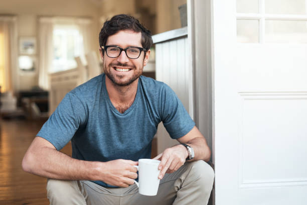 Cropped portrait of a handsome young man enjoying a cup of coffee in the morning