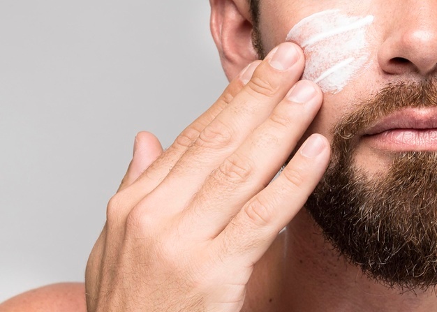 Man putting on face cream