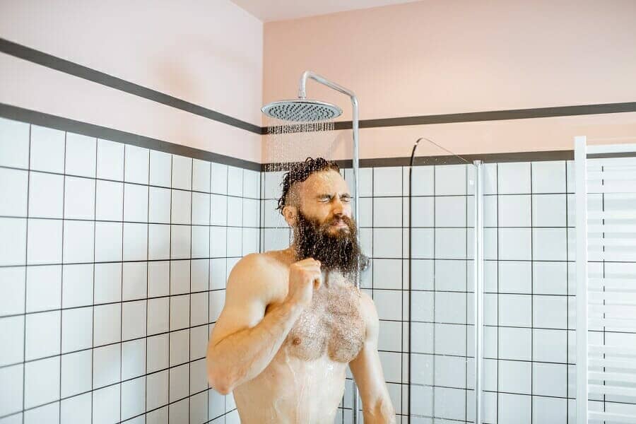 Handsome man taking shower 