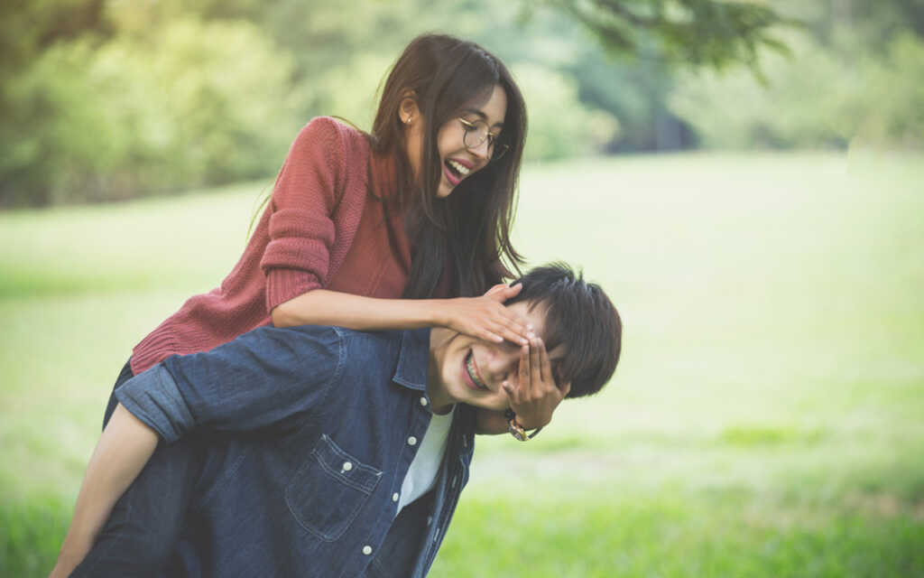 Couple Of Love A Man Carry A Girl On His Back In Park 
