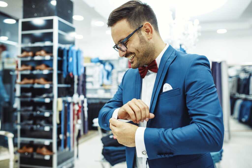 smiling-young-man-buying-clothes