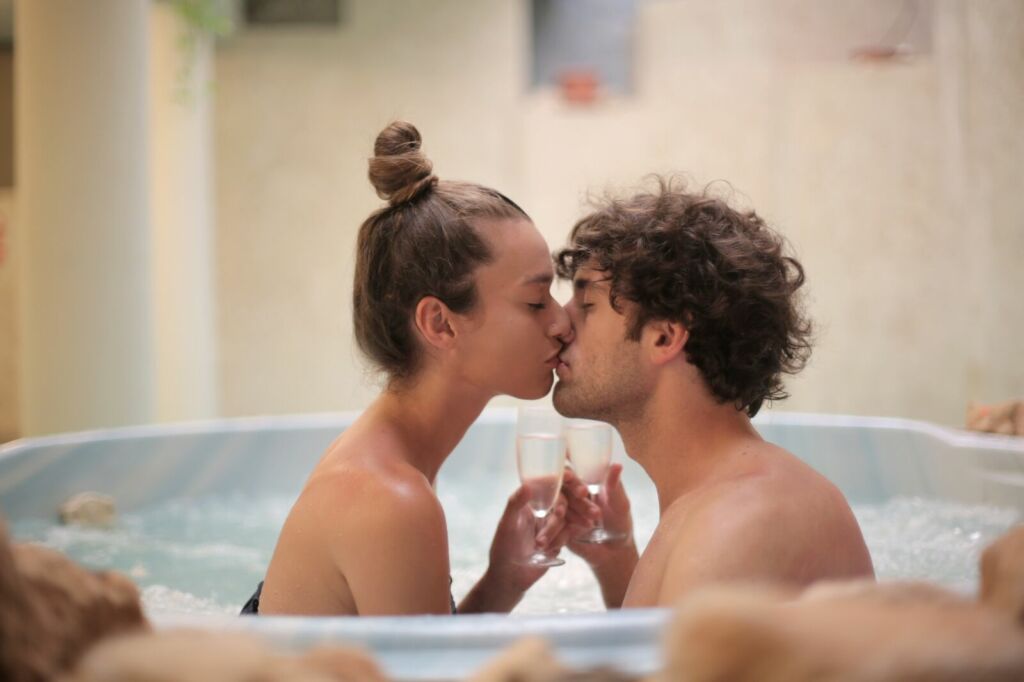 Happy couple kissing in bath 