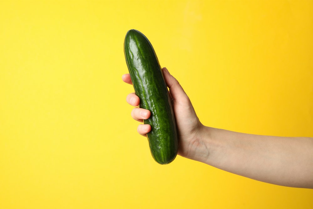 man holding cucumber