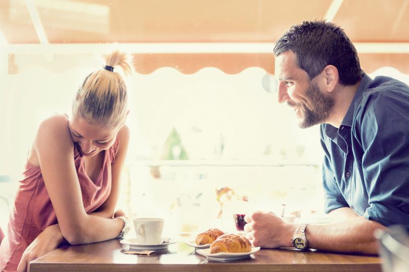 Couple Talking In Cafe 